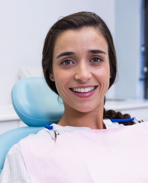 Woman with healthy beautiful smile after comprehensive dentistry