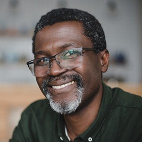 Senior man with glasses smiling