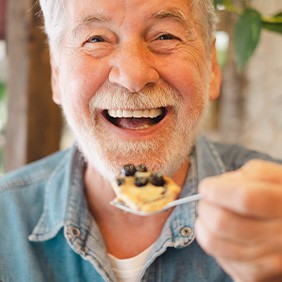 Senior man about to eat a spoonful of food