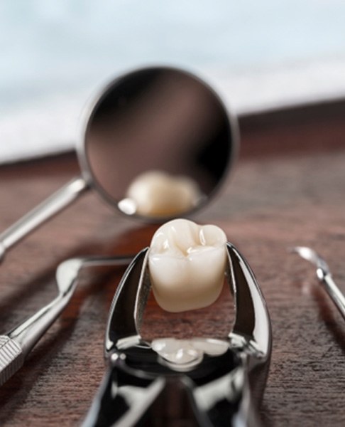 Dental instruments with an extracted tooth on a table