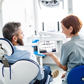 Patient filling out dental insurance form in lobby