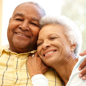 happy older couple after learning how implants can save you money
