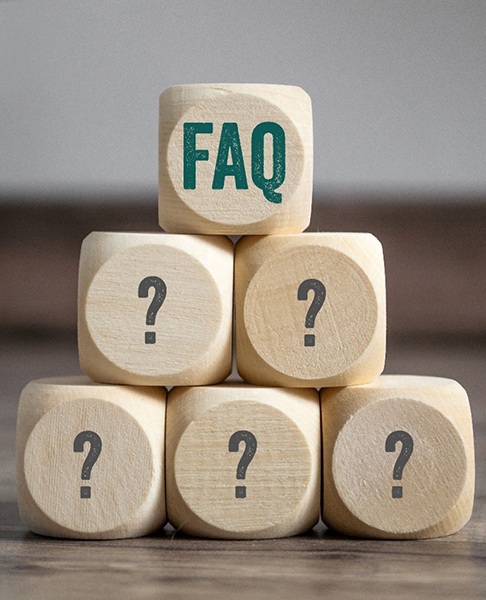 Pyramid of wooden blocks with question marks and FAQ 