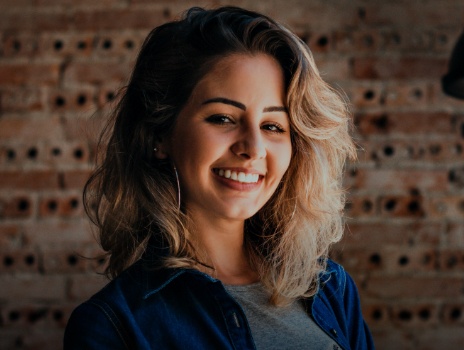 Woman sharing flawless smile after Invisalign treatment