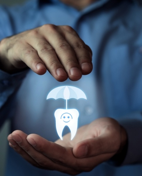 Hands holding animated tooth and umbrella