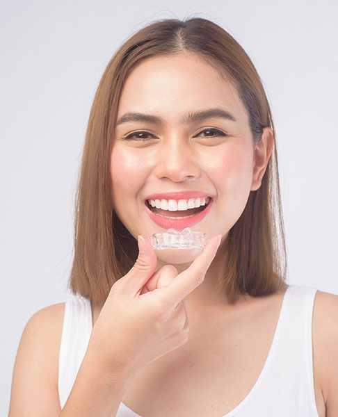 Woman inserting clear aligners