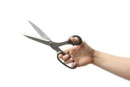 Person holding black pair of scissors