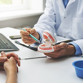 A patient talking with their dentist about treatment