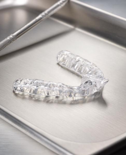 Clear nightguard for teeth grinding on metal tray