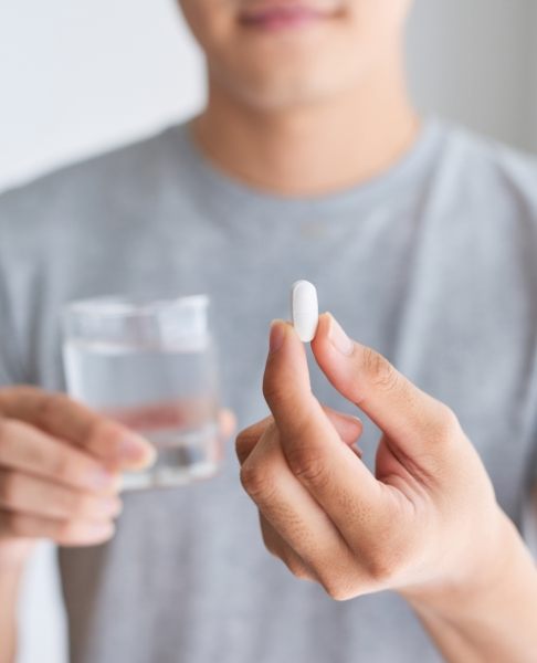 Man holding an oral conscious dental sedation pill