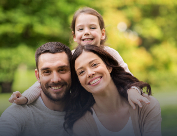 Mother father and child smiling together after receiving prevnetive dentistry