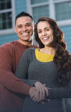 Man and woman sharing healthy smiles after periodontal therapy