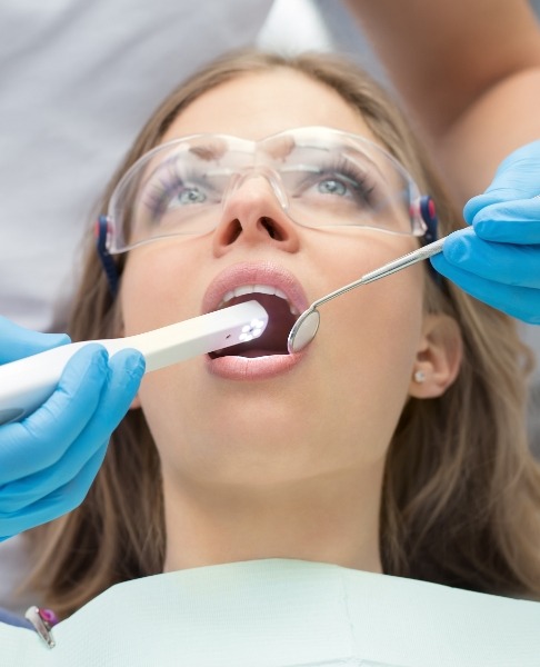 Dentist using intraoral camera to capture smile images