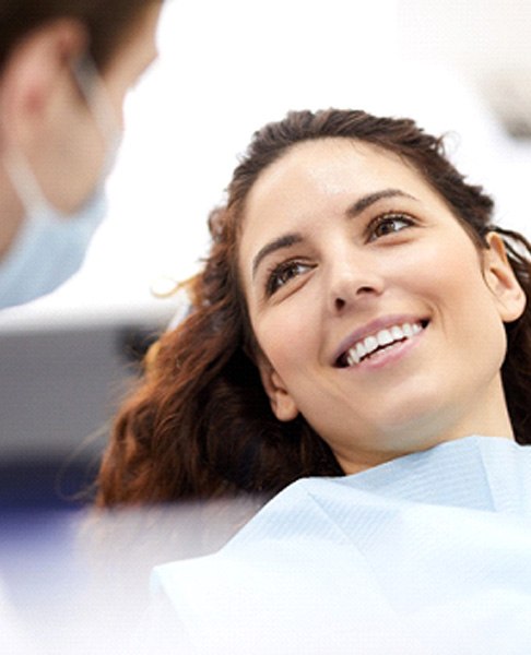 A young woman smiling at her dentist