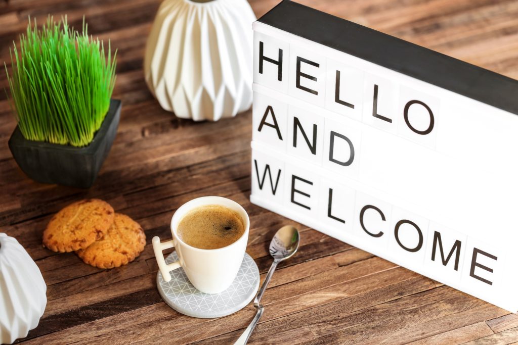 Lighting box that says hello and welcome next to coffee