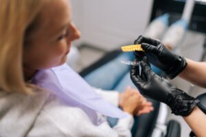 a dentist showing a patient how Invisalign aligners work