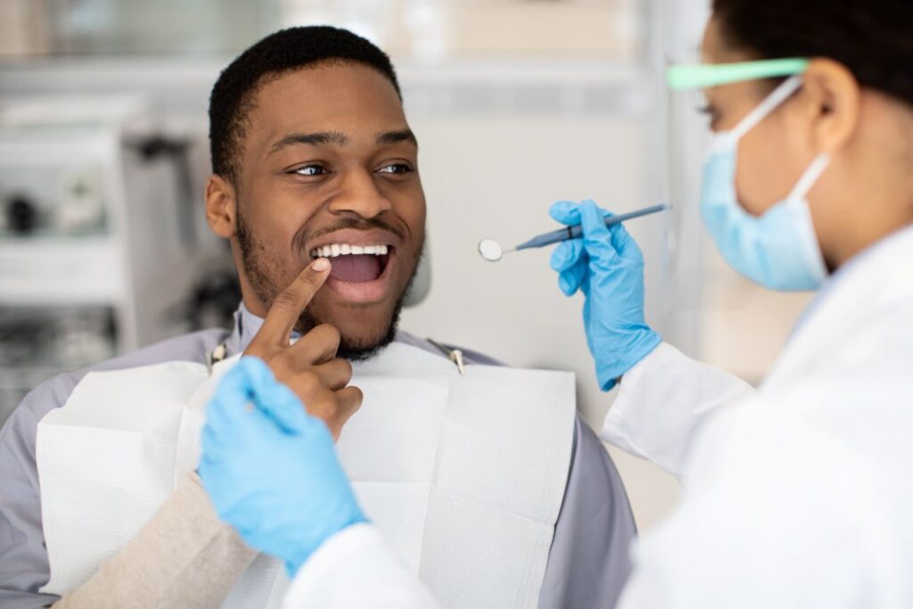 A man receiving a dental exam and cleaning