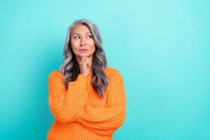 Senior woman making a questioning pose on blue background